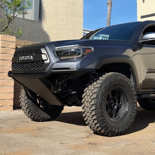 Gray Toyota truck parked in front of a house with a palm tree in the background